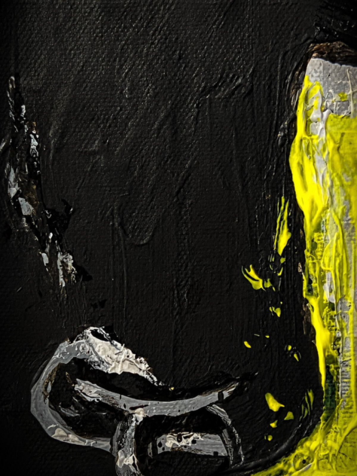 The nose ring in silver against black, with fluorescent yellow running down the right