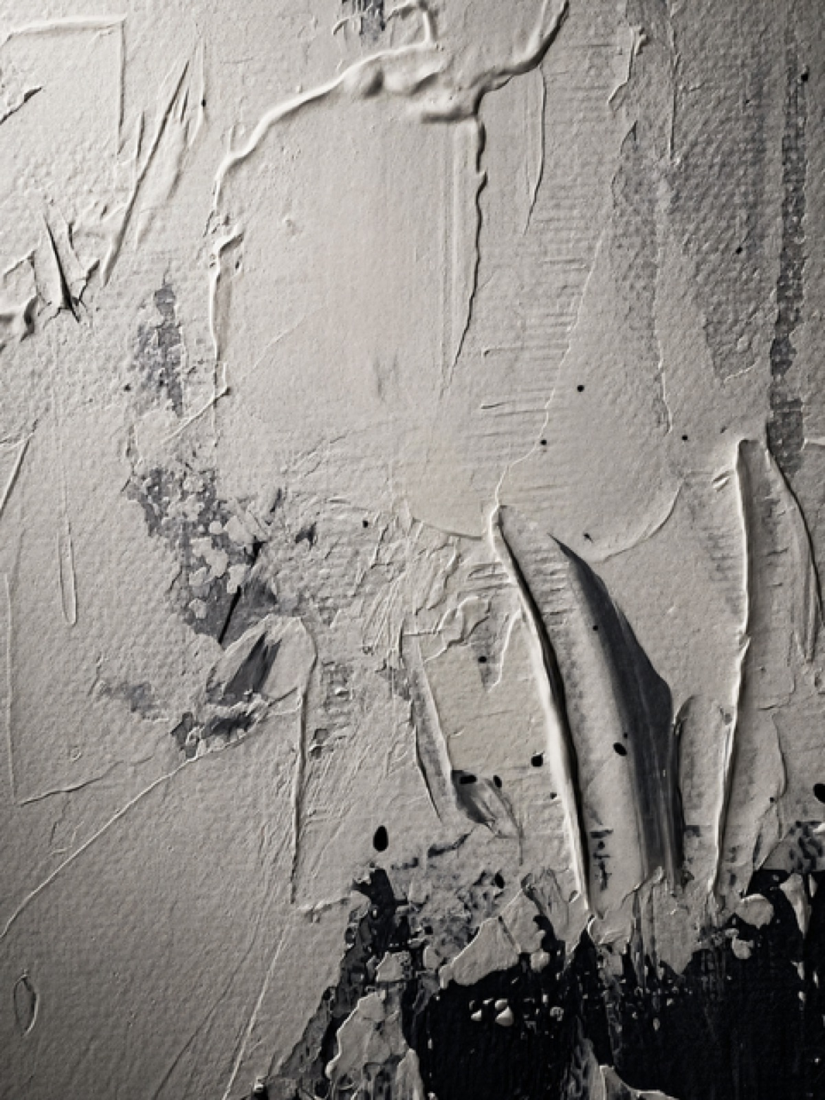 White impasto raked into ridges, the black underpainting showing at the edge